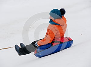 People have fun riding the snow slides on the tubing