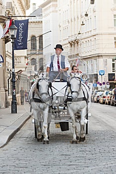 People have a ride in the horsedrawn carriage called fiaker