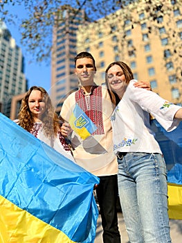 People have a Ukrainian flag on their shoulders in honor of defenfers of Ukraine Vancouver rally Art Gallery Ukrainians