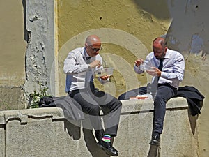 People having Lunch Break. Two men eating.