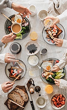 People having brunch together and talking, top view