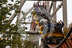 People having fun amazing roller coaster during vacation