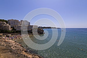 People having fun at Cala Llenguadets beach in Salou