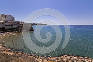 People having fun at Cala Llenguadets beach in Salou