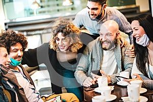 People having fun drinking cappuccino at coffeehouse - Young friends talking together at restaurant cafeteria