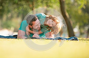 People having fun outdoors. Concept of happy vacation and friendly family. Happy father and son embracing and hugging