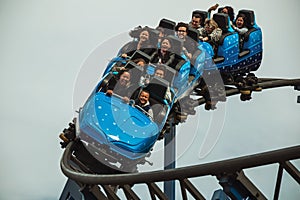 People having fun on a roller coaster