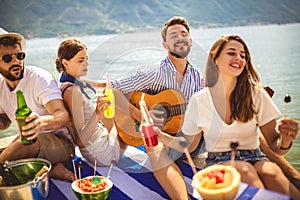 People having fun on summer vacation.Happy friends drinking tropical cocktails on the beach