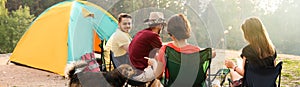 People having lunch near camping tent outdoors. Banner design