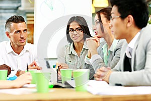 People having meeting around table