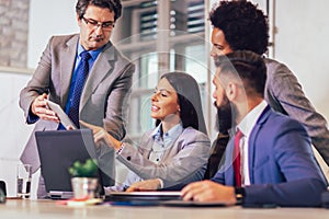 People having meeting around table in modern office