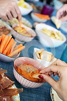 People having some appetizers on a colorful table