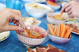 People having some appetizers on a colorful table