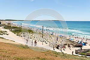 People heading to overcrowded Elouera beach on Australia day. People swimming and sunbathing on hot