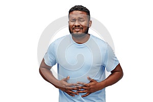 Unhappy man suffering from stomach ache photo