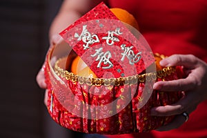 People held the Orange basket With Blessing Red Envelope for Chinese New Year Gifts