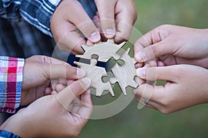 People helping in assembling puzzle, cooperation in decision making, team support in solving problems and corporate group teamwork