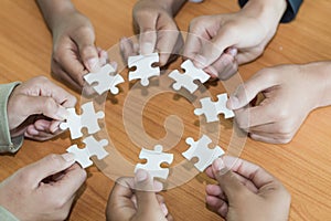People helping in assembling puzzle, cooperation in decision making, team support in solving problems and corporate group teamwork