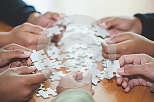 People helping in assembling puzzle, cooperation in decision making, team support in solving problems and corporate group teamwork