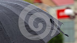 People hide from rain under umbrellas in a rainy day on the street of the city Bad weather concept