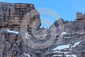 People hiking in the rocks of the Italian Alps