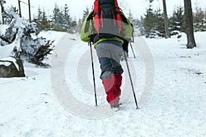 People hiking on snow trail in winter