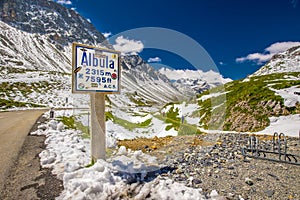 People hiking on the top of Albula pass in Swiss Alps photo