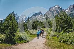 People hiking toward the Teton mountain range in Grand Teton National Park