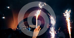 people hold firework in hand to celebrate happy new year birthday