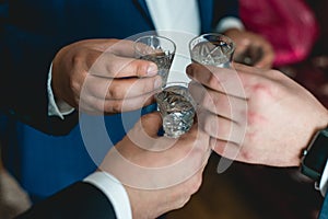People hold in hands glasses with alcohol. Wedding party.