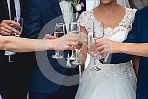 People hold in hands glasses with white wine. wedding party.