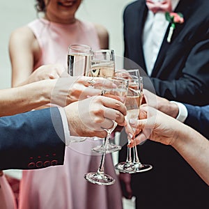 People hold in hands glasses with white wine. wedding party.