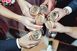 People hold in hands glasses with white wine. wedding party.