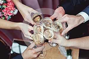 People hold in hands glasses with white wine. wedding party.