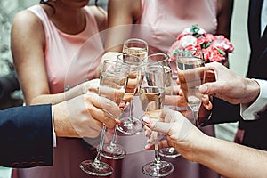 People hold in hands glasses with white wine. wedding party.