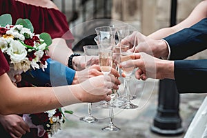 People hold in hands glasses with white wine. wedding party.