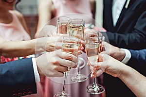 People hold in hands glasses with white wine. wedding party.