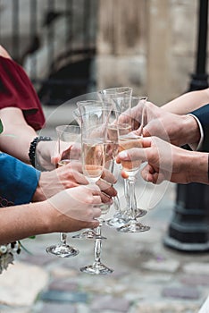 People hold in hands glasses with white wine. wedding party.