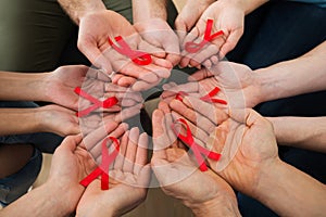 People holding aids ribbon