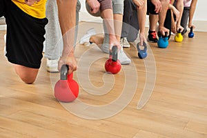 People holding colorful kettle bell