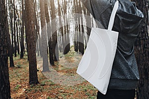 people holding cotton bag for mockup blank in nature