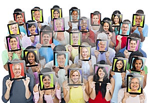 People Holding Devices with their face on it