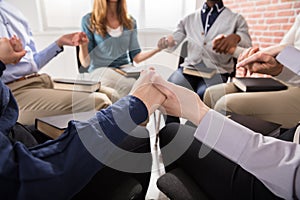 People Holding Each Others Hand Praying Together