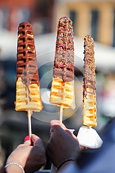 People are holding fresh baked wafles