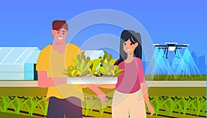 people holding green plants air drone watering field smart farming responsibility of co2 emission environmental