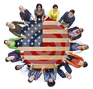 People Holding Hands Around the Table with American Flag