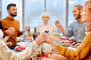 People holding with hands, praying before eating