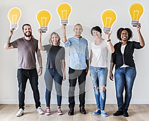 People holding lightbulb icons together