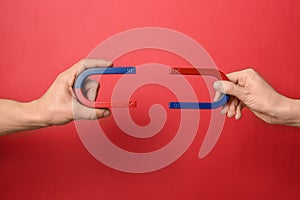 People holding magnets on color background