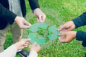 People holding recycle symbol against green spring background. Earth day holiday concept